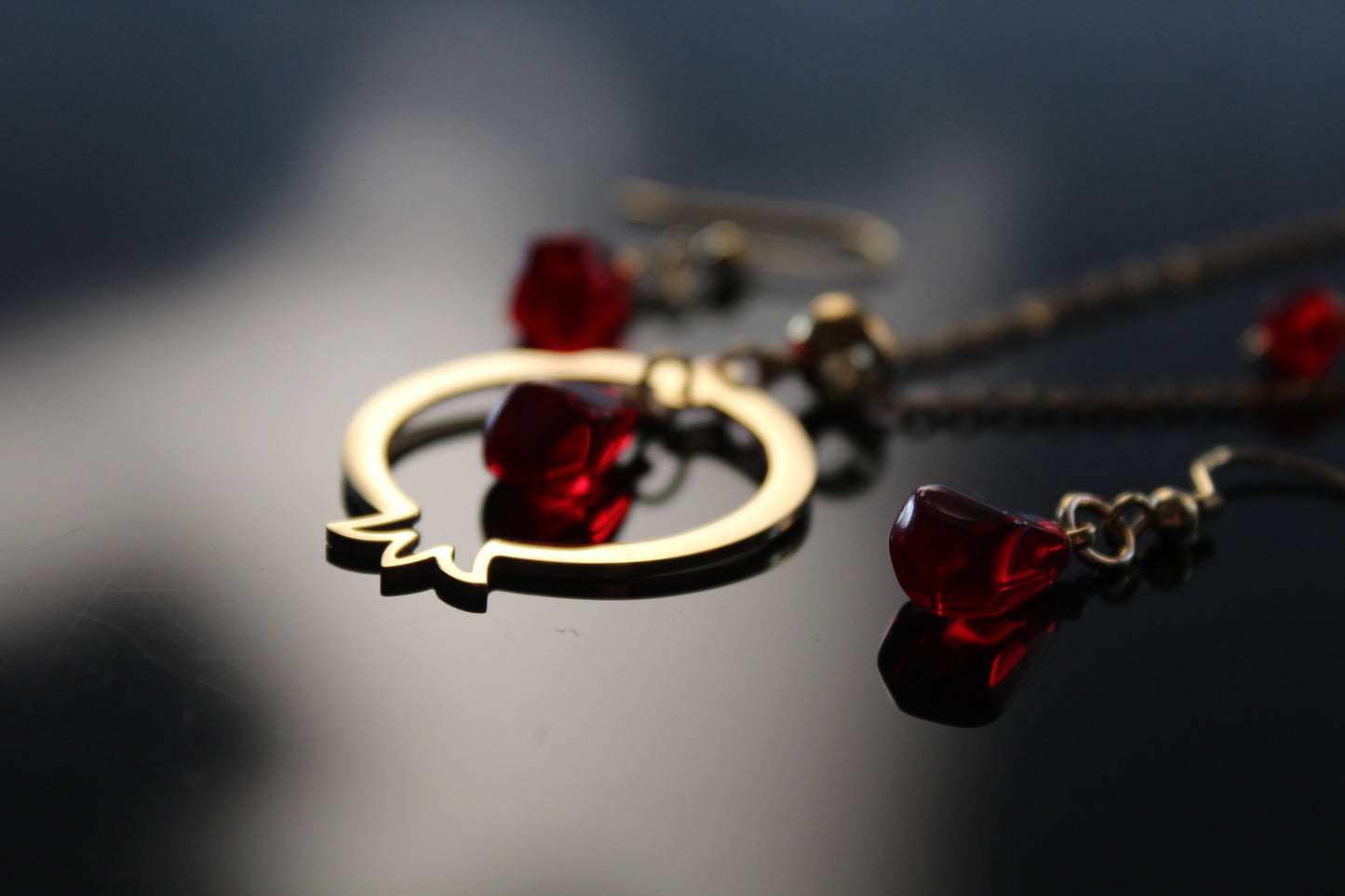 Pomegranate-shaped pendant and delicate matching earrings with glass beads