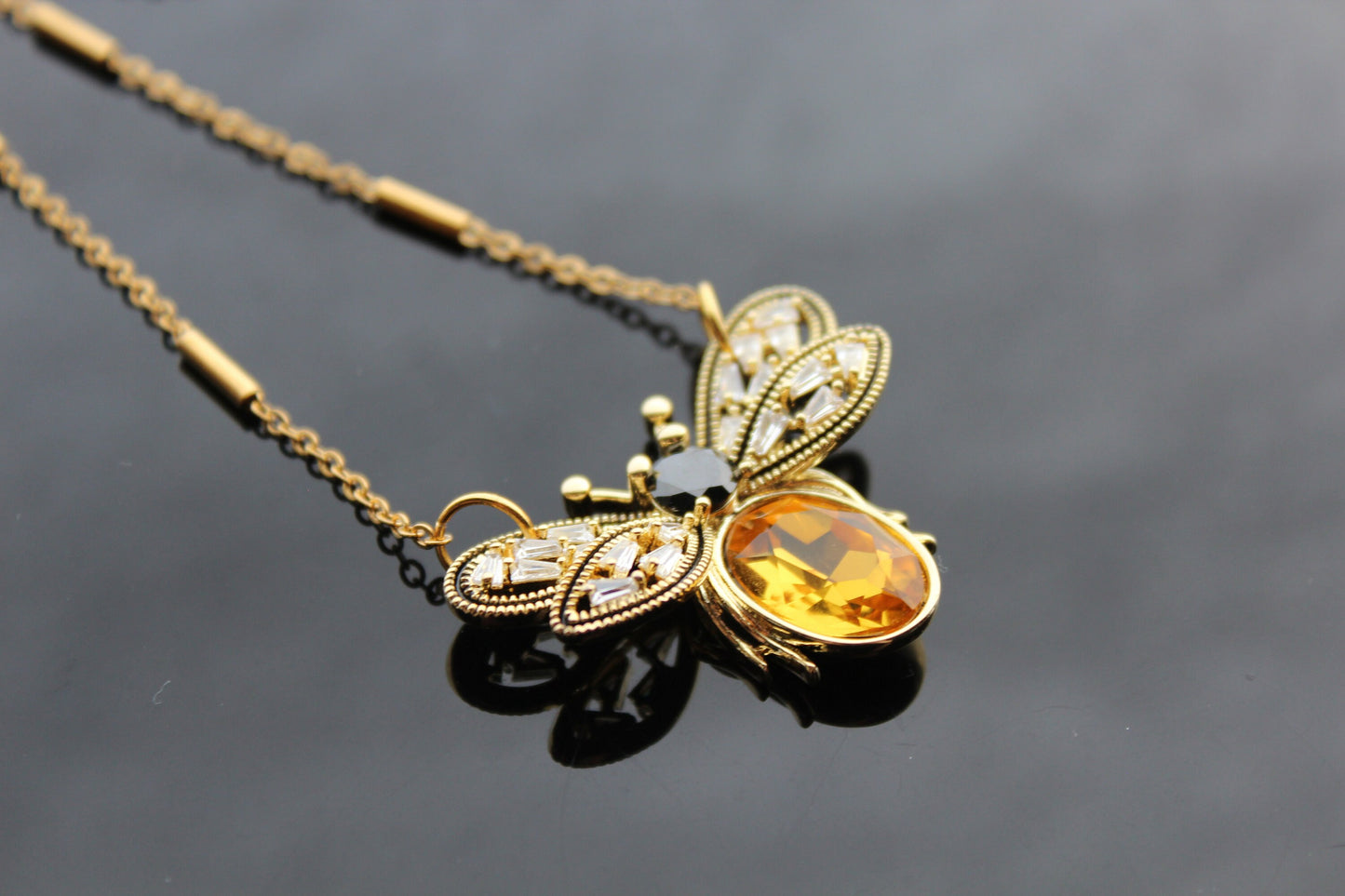 Gold plated bee pendant with natural onyx and crystals
