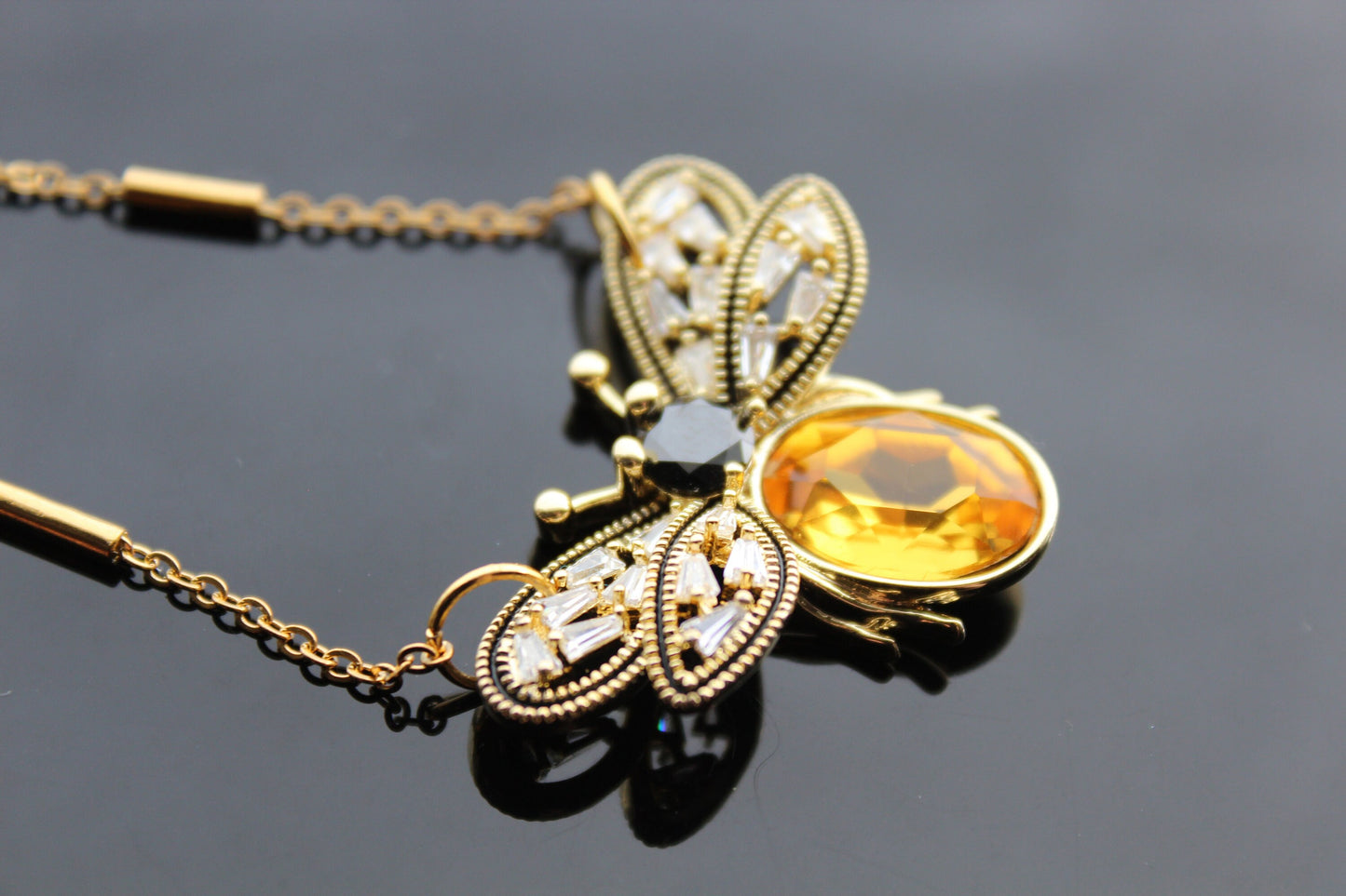 Gold plated bee pendant with natural onyx and crystals