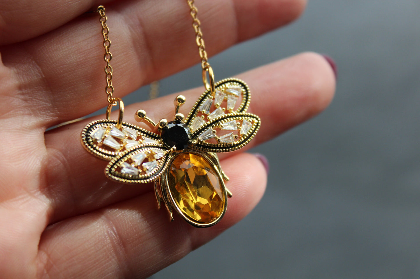 Gold plated bee pendant with natural onyx and crystals