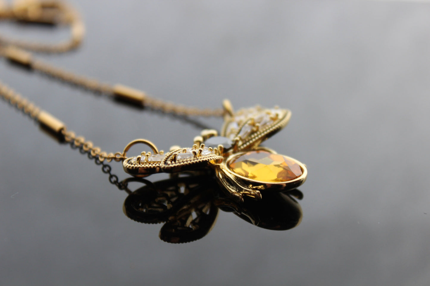 Gold plated bee pendant with natural onyx and crystals