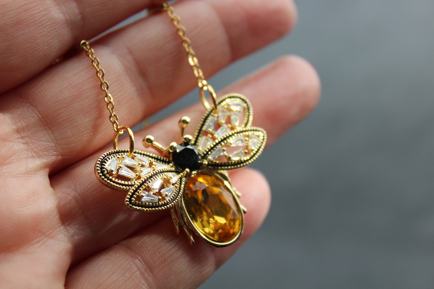 Gold plated bee pendant with natural onyx and crystals