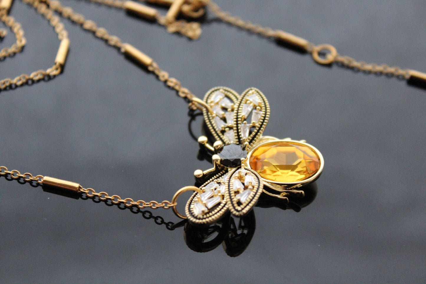 Gold plated bee pendant with natural onyx and crystals