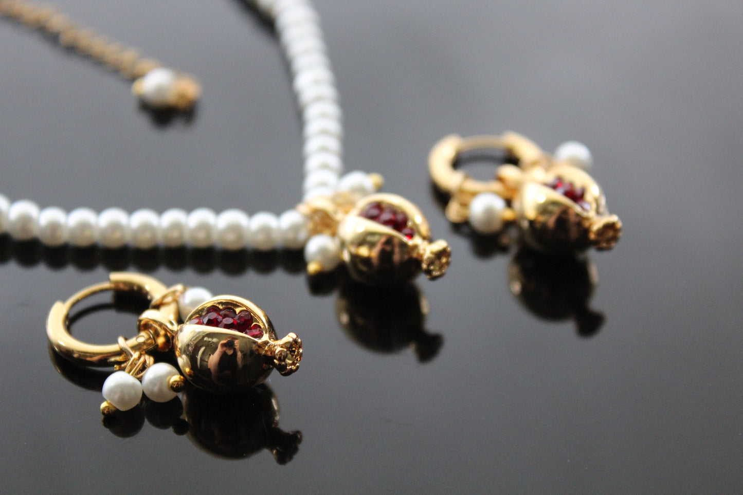 Gold plated pomegranate hoop earrings with red zircons ang glass pearl stand choker