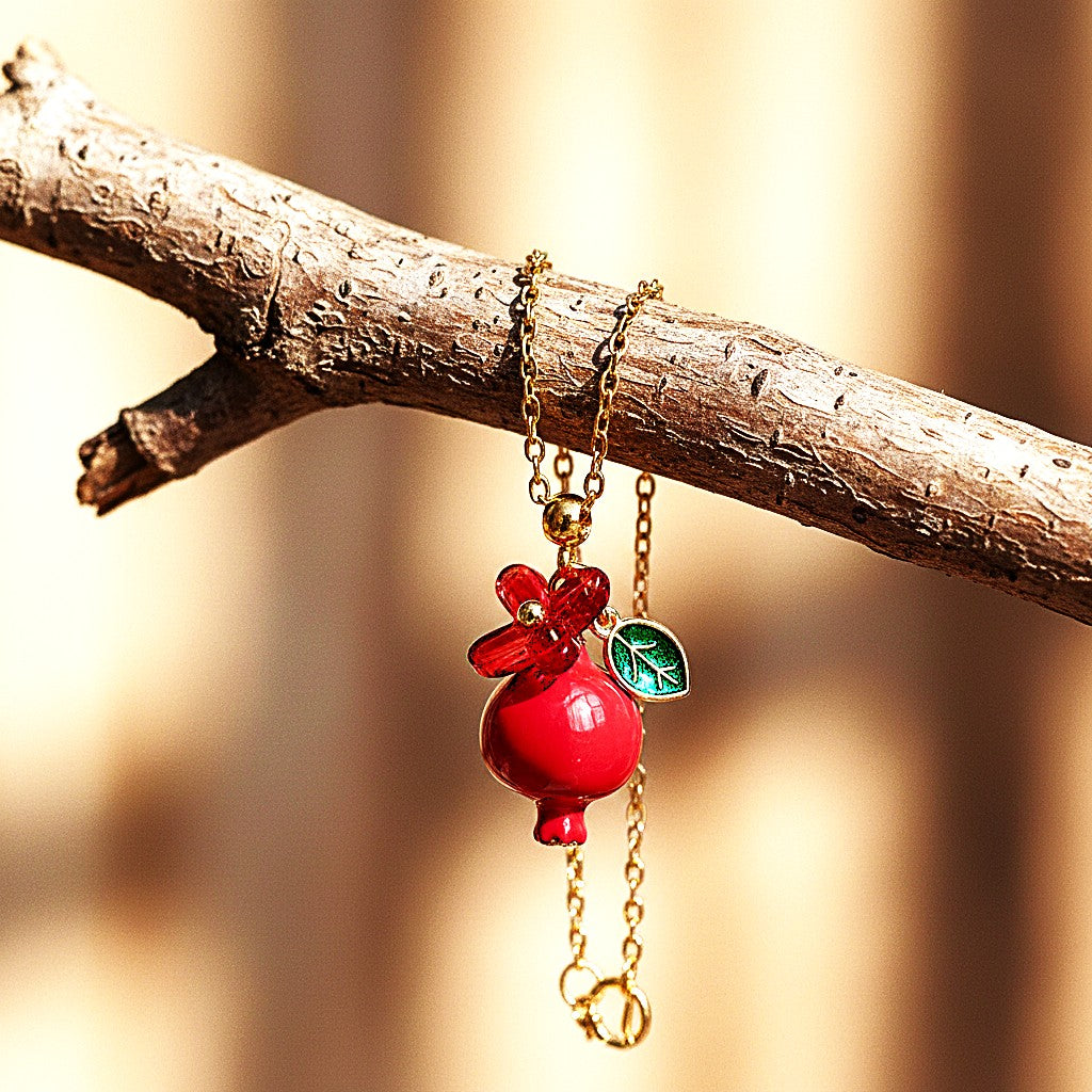 Handmade pomegranate enamel pendant with glass flower and enamel green leaf
