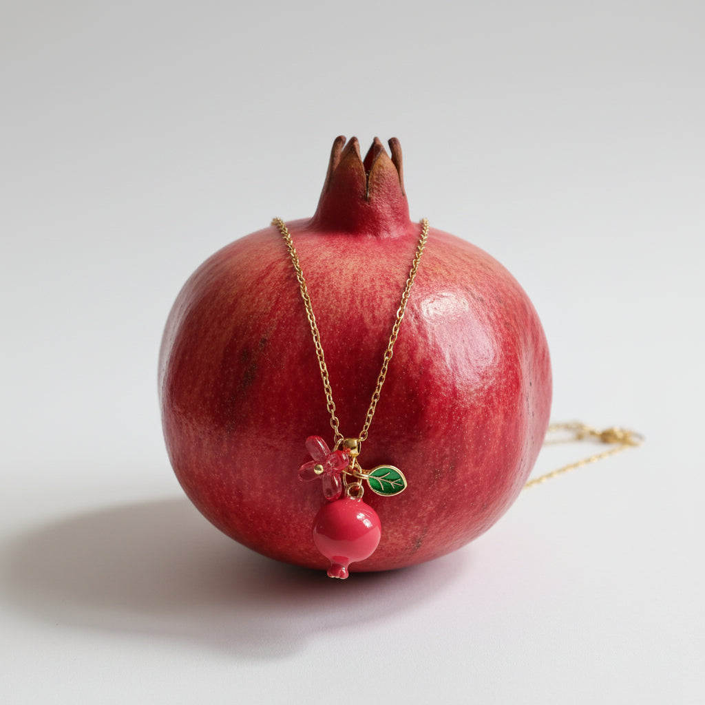 Handmade pomegranate enamel pendant with glass flower and enamel green leaf