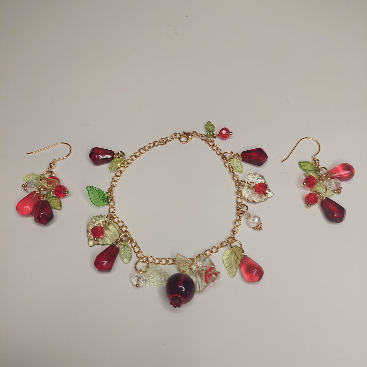 Handmade pomegranate jewelry with hypoallergenic gold plated stainless steel hardware and resin glass beads