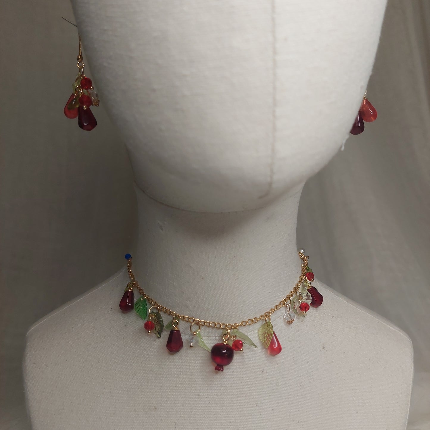 Handmade pomegranate jewelry with hypoallergenic gold plated stainless steel hardware and resin glass beads