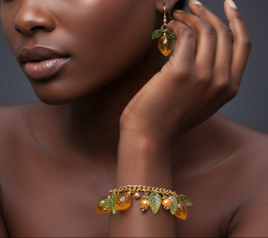 A handcrafted lemon-themed bracelet with gold-toned chain and yellow translucent bead charms, accompanied by a pair of matching earrings