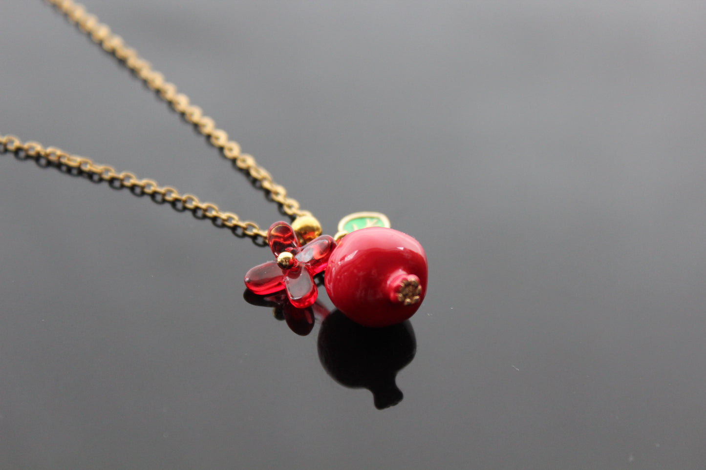 Handmade pomegranate enamel pendant with glass flower and enamel green leaf