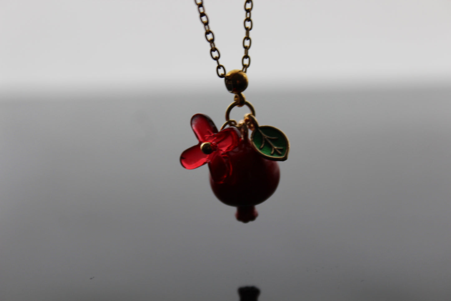 Handmade pomegranate enamel pendant with glass flower and enamel green leaf