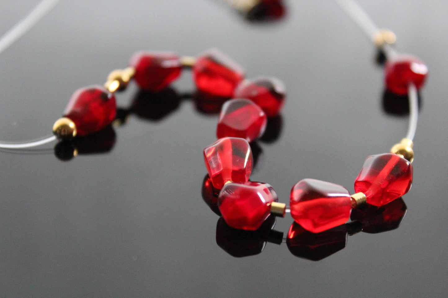 Pomegranates resin seeds on see-through wire